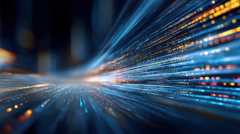Abstract image of blue and orange light trails and digital lines moving at high speed, representing data flow or futuristic technology. The scene gives an impression of rapid movement and energy.